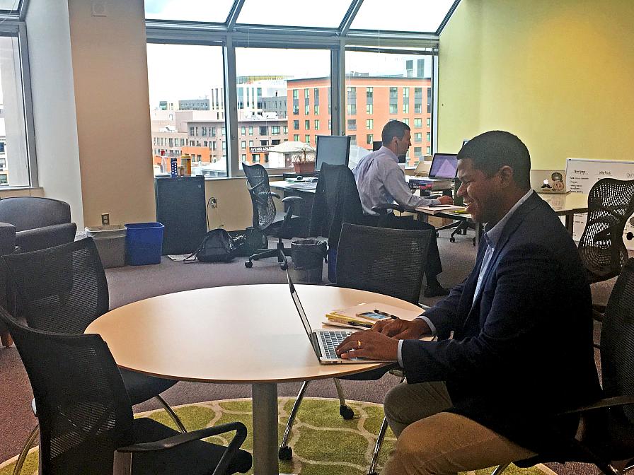 Matthew Henry, Data Resource Specialist at Exceptional Lives, works at a shared table in SIF's Coworking Space