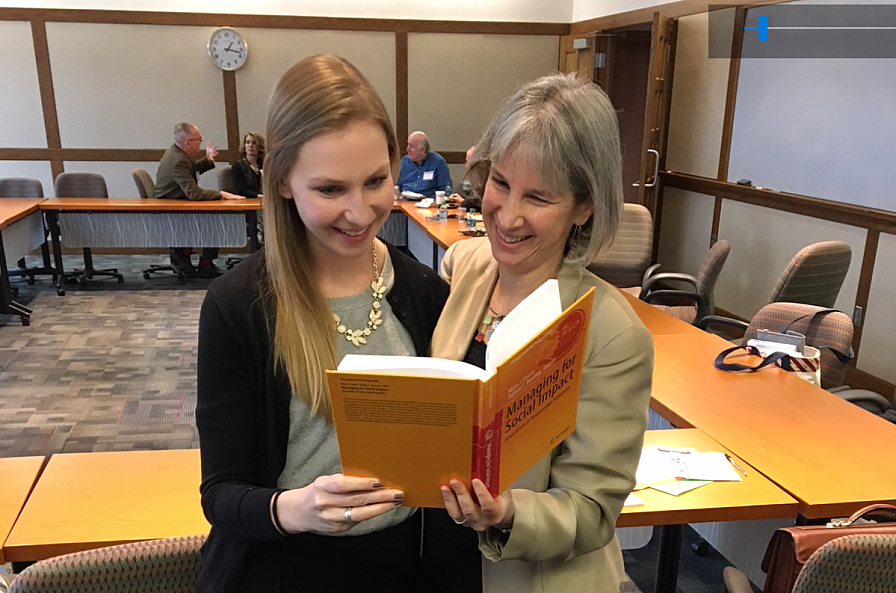 Susan Musinsky and Anna Trieschmann reading Managing for Social Impact
